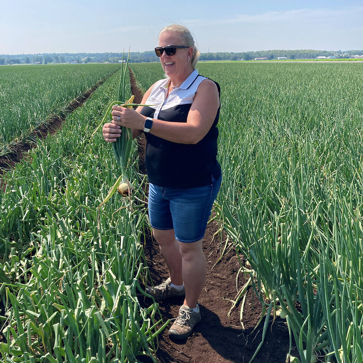 Alliance Agri-Turf employee with products at crop