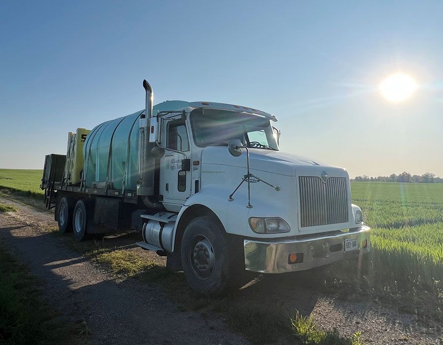 Photo of Alliance Agri-Turf delivery truck with sun and field in the background core beliefs of Alliance Agri-Turf