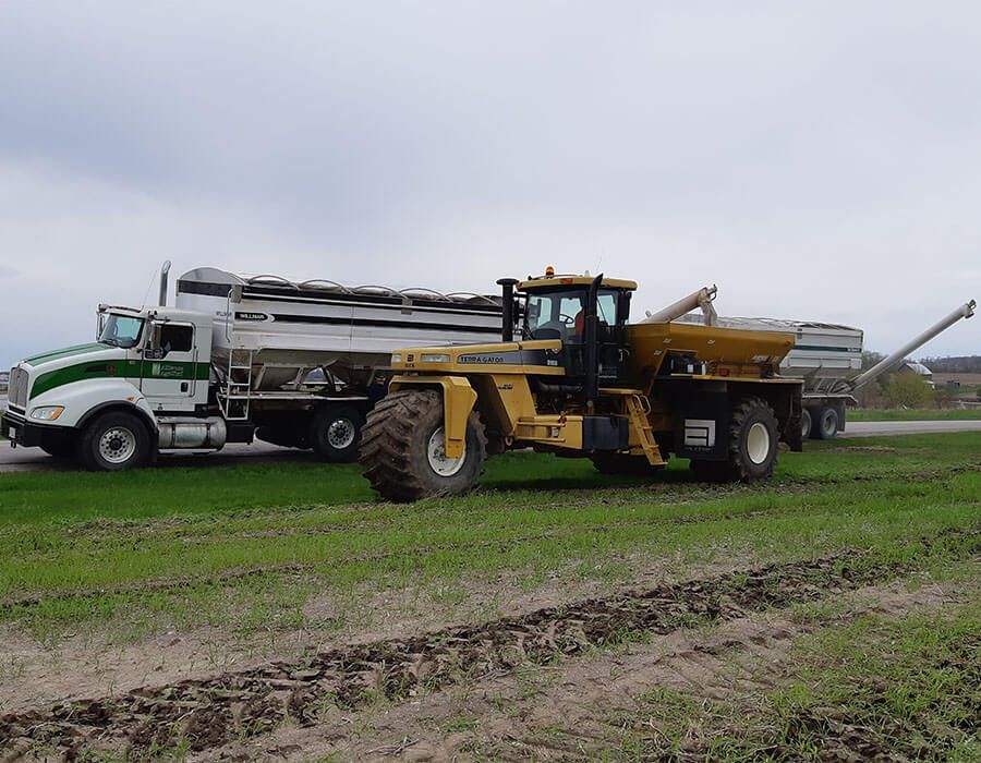 Photo of Alliance Agri-Turf's terragator and delivery truck on green grass Alliance Agri-Turf's Services & Delivery