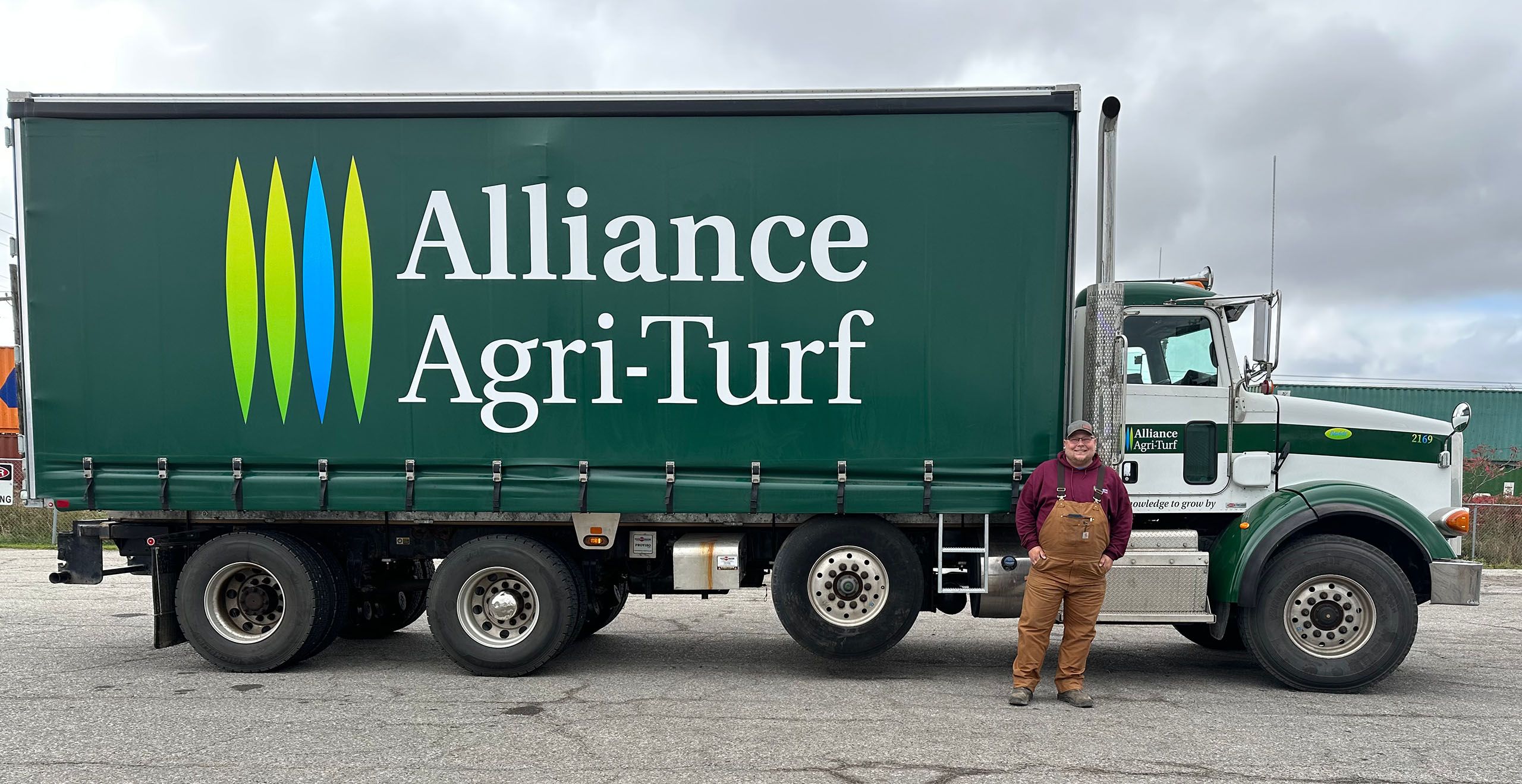 Alliance Agri-Turf employee standing beside truck