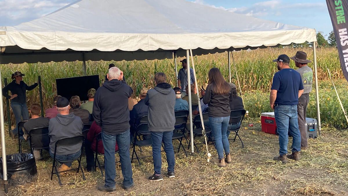 People gathering under a canopy for an event.